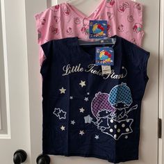 Uniqlo X Sanrio Little Twin Stars Girls T-Shirts *New With Tags *Size 11 Girls (Height 57-61", Bust 28-30") *(2) T-Shirts: -Navy Blue Glitter Little Twin Stars -Pink Multi Sanrio Characters *Round Neckline *Short Sleeves *Materials: Cotton Playful Blue T-shirt For Loungewear, Casual Pink T-shirt For Pajama Party, Cute Blue T-shirt For Loungewear, Cute Short Sleeve T-shirt With Star Print, Cute Character Print Tops For Loungewear, Cute Tops With Character Print For Loungewear, Graphic Print Short Sleeve Bedtime Top, Cotton Cartoon Print Tops For Bedtime, Casual Cartoon Print Tops For Pajama Party