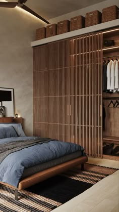 a bedroom with a bed, closet and hanging clothes on the wall in it's corner