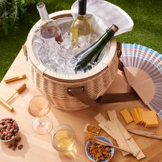 a picnic table with wine, cheese and crackers