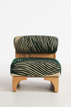 a green and white zebra print chair with wooden legs on a white background, it appears to be made out of wood