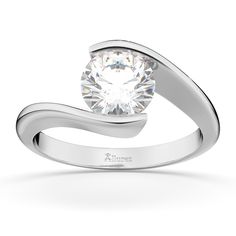 a white gold ring with a round diamond in the center and a curved band around it