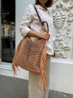 Handcrafted with care, this net bag is a true gem for women who appreciate unique accessories. Made from raffia  this handmade bag exudes charm and elegance. The perfect blend of style and functionality, this raffia bag is a versatile accessory that can elevate any outfit effortlessly.   MATERIALS and BENEFITS  Take a look at our collection of natural bags made from raffia - the most environmentally friendly material! Each bag impresses with its natural beauty and unique character, thanks to high-quality raffia, which is an excellent alternative to synthetic materials. The advantages of raffia bags are evident: they are lightweight, durable, and have a long service life. Additionally, their natural appearance and texture add a special charm to every outfit. Our bags are perfect for walks, Shoulder Bag Crochet, Raffia Tote Bag, Summer Tote Bag, Summer Tote Bags, Straw Beach Bag, Summer Tote, Unique Accessories, Woven Tote Bag, Net Bag