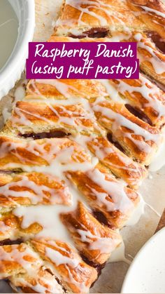 a pastry with icing sitting on top of a cutting board