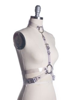 "She's dead... wrapped in plastic". This clear PVC wrap style harness is inspired by Laura Palmer in Twin Peaks. Fit is adjustable at front and sizes with buckles. Detachable choker collar can be worn separately. Also available in vegan leather or leather. Silver-toned nickel plated steel hardware. All pieces are MADE TO ORDER, standard sizes XS-4XL. If your measurements fall outside these standards or you are unsure of what size to order, select "CUSTOM" and include your measurements in the not Edgy Strapped Party Harness, Edgy Strapped Harness For Parties, Adjustable Edgy Harness For Cosplay, Edgy Adjustable Harness With Belt, Adjustable Strapped Harness For Cosplay, Adjustable Punk Harness For Parties, Adjustable Belt Harness For Cosplay, Adjustable Strapped Punk Harness, Adjustable Strapped Harness With Belt