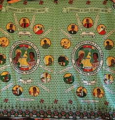 a green and yellow blanket with pictures of people in different countries on it's sides