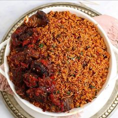 a white bowl filled with rice and meat