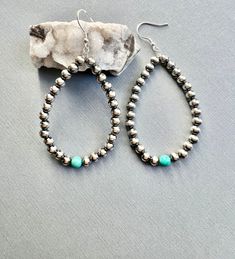 Native American Indian Jewelry.  Gorgeous handcrafted Navajo Pearl Hoops with Turquoise.  A style of earrings the Navajo Artist's are well known for these are made by the talented Navajo artisan Mason Lee.  Made from Turquoise & 5mm Sterling Silver Navajo Pearls.  These measure  3"L x 1 1/2"W.  Beautiful craftsmanship in a in a traditional design will certainly be a great gift yourself or for a special person under the tree!    Please look at all photos closely. Welcome to NorthWestTradingCo Rustic Nickel-free Round Bead Jewelry, Artisan Adjustable Hand-strung Earrings, Southwestern Teardrop Jewelry For Festivals, Adjustable Southwestern Teardrop Jewelry, Southwestern Adjustable Teardrop Jewelry, Southwestern Style Silver Beaded Dangle Jewelry, Artisan Hand-strung Teardrop Jewelry, Southwestern Turquoise Nickel-free Hoop Earrings, Handmade Southwestern Turquoise Hoop Earrings