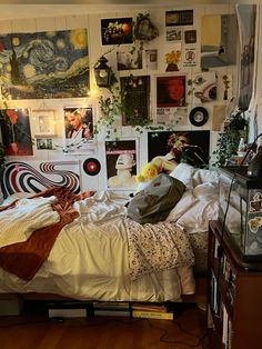 a bedroom with many pictures on the wall