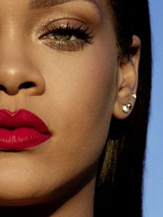 a close up of a woman's face with bright red lipstick on her lips