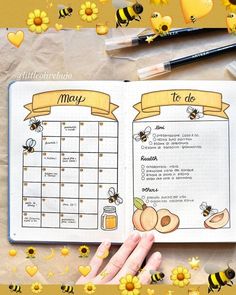 an open planner with bees and honey on it