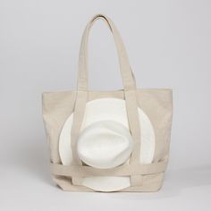 The Original Canvas Traveler Bag- Solid Natural – Hat Attack New York Cheap Versatile Beach Bag For Everyday Use, Cheap White Bucket Beach Bag, Cheap White Bucket Bag For Vacation, Cheap Functional Beach Bags, Cheap Summer Bucket Bag For Travel, Cheap Recyclable Beach Bag For Travel, Affordable Travel Beach Bag, Cheap Cream Beach Bag With Adjustable Strap, Beach Bag With Hat