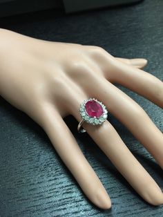 6.15 Carats Impressive Natural Red Ruby and Diamond 14K White Gold Ring Total Red Ruby Weight is: Approx. 5.15 Carats Ruby Measures: Approx. 11.00 x 9.00mm Natural Round Diamonds Weight: Approx. 1.00 Carat (color G-H / Clarity SI1-SI2) Ring total weight: Approx. 6.0 grams Disclaimer: all weights, measurements and colors are approximate and may vary slightly from the listed dimensions or as seen in the image. All pictures are magnified to show the smallest of details. Please, refer to the item de Luxury Ruby Cluster Ring, Luxury Red Cluster Diamond Ring, Elegant Gia Certified Ruby Ring, Elegant Gia Certified Oval Ruby Ring, Classic Pink Cluster Ring For Formal Occasions, Luxury Red Cluster Ring, Gia Certified Platinum Ruby Ring, Gia Certified Fine Jewelry Ruby Ring In Platinum, Gia Certified Platinum Ruby Ring In Fine Jewelry