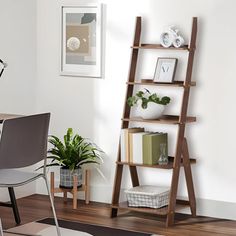 a room with a table, chair and bookshelf in the middle of it