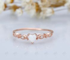 Introducing our Opal Heart Ring, a delicate and enchanting piece that embodies elegance and simplicity. This dainty opal ring features a beautiful heart-shaped opal gemstone, exuding a mesmerizing play of colors that captures the eye. Crafted with a minimalist design, it is perfect for stacking with other rings to create a personalized and unique look. As the October birthstone, opal is a symbol of hope and purity, making this ring an ideal gift for her on any occasion, whether it's an anniversa