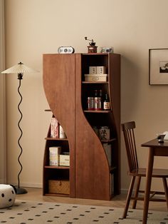 a room with a table, chair and bookcase in it