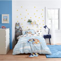 a child's bedroom with blue walls, white furniture and yellow stars on the wall