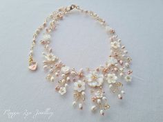 A truly beautiful bridal necklace, handmade with hand carved Mother of pearl flowers, quality natural ivory and blush pink freshwater pearls with Champagne Swarovski crystals set on a Gilt gold plated, copper wire showing intricate detailing. The necklace is around 40cm with an extension chain to lengthen if you please. The drop on the necklace, at its widest point is around 5.5-6 cm. All of our items are made to order so adjustments can be made with regards to materials and designs. Please mess Bridal Necklace Gold, Gold Wedding Necklace, Rose Gold Pearl Necklace, Mother Of The Bride Jewelry, Pearl Necklace Bridal, Rose Gold Bridal Jewelry, Gold Necklace Wedding, Gold Bridal Necklace, Summer Jewellery