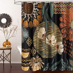 a shower curtain with an orange flower and leaves design on it next to a white brick wall