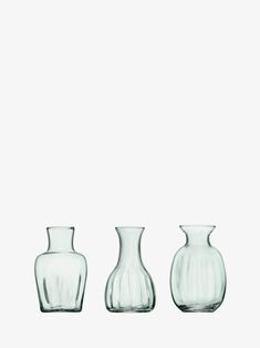 three glass vases sitting next to each other