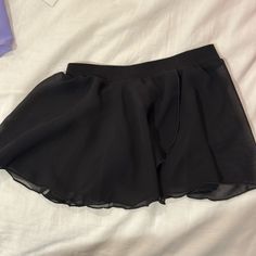 Black Polyester Ballet Skirt. Nwot. Kids Size Small. Fitted Black Dancewear Bottoms, Fitted Black Skort With Elastic Waistband, Black Mini Skirt For Dance, Black Mini Skirt Skort For Cheerleading, Black Stretch Skirt For Cheerleading, Black Dance Skirt For Dancewear, Black Flowy Skort With Elastic Waistband, Black Mini Skirt For Cheerleading, Fitted Black Dancewear Skirt