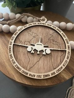 a wooden necklace with an airplane on it and the words in arabic are engraved into the wood