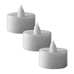 three white candles sitting next to each other