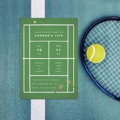 a tennis racket, ball and calendar on a blue court with white lines in the background