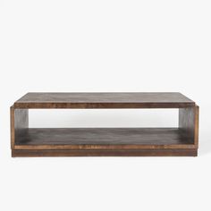 a wooden coffee table sitting on top of a white wall