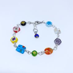 "The beautiful patterns in this Millefiori bracelet pair well with so many styles; the bright, floral designs create unique results with each custom order. This colorful jewelry piece makes a memorable gift with an optional monogram charm, or treat yourself just because. This bracelet has quality, handcrafted .925 sterling silver bead chain with varying Millefiori glass patterns and a great multicolor appeal. Millefiori or \"thousand flowers\" glass art is an ancient technique practiced by lampw Sweet Alyssum, Murano Jewelry, Murano Glass Jewelry, Bead Store, Glass Bracelet, Colorful Jewelry, Bead Chain, Silver Bead, Bracelet Argent