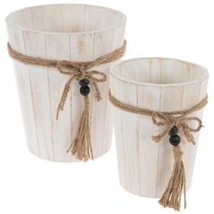 two white buckets with rope and beads on them