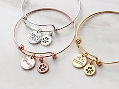 "Dog Mom Bracelet - Personalized Birthstone Bracelet, Paw Print Bracelet, Pet Memorial Bracelet, Our Personalized Dog Mom Bracelet includes an engraved disc, a paw print charm, and up to 10 Swarovski birthstone dangles. Choose from silver or gold and new font choices. Disc can be engraved with a name, date, or nickname. TO ORDER: 1) Select your quantity 2) Select your metal color + number of birthstones 3) Select your font 4) Enter the text to engrave on the disc, and your birthstones in the per Adjustable Round Bracelet As Best Friend Gift, Charms Bracelet For Mother's Day, Mother's Day Bracelets With Charms, Charms Bracelets For Mother's Day, Nickel-free Bracelet For Best Friend Gift, Mother's Day Charms Bangle Bracelets, Adjustable Charms Bangle, Adjustable Name Bracelet With Charms, Hand-stamped Round Bracelet For Mother's Day