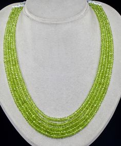 PRODUCT DETAILS LINE 5/CTS 389 PERIDOT FACETTED ROUND BEADS  ALL NATURAL GEMSTONE  FINE PARROT GREEN COLOR EXCELLENT COLOR & LUSTRE SIZES OF THE BEADS ARE FROM 5MM TO 4MM NECK LENGTH OF THE NECKLACE IS 16 INCHES  OUTER LENGTH OF THE NECKLACE IS 18 INCHES  BEST COLOR PERIDOT  ATTACHED TO SIZABLE SILK CORD BUY IT NOW... NOTE - #You will receive the same product you see in picture. #DEAR BUYERS PLEASE FEEL FREE TO ASK QUESTIONS  #WE WILL BE GLAD TO ANSWER & SOLVE QUERY REGARDING THIS PRODUCTS #RETU Parrot Green Necklace, Parrot Green, Round Bead Necklace, Peridot Jewelry, Peridot Necklace, Fancy Beads, Gemstone Beaded Necklace, Best Color, Silk Cord