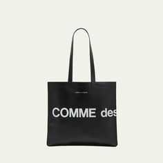 Comme des Garcons tote bag in smooth leather features a "Huge Logo" design Foiled logo lettering Two flat top handles Open top Interior, one zip pocket Approx. 25.984"H  x 15.748"W x 0.787"D Leather Imported Designer Bags With Logo For Daily Use, Designer Tote Bag With Logo, Luxury Shoulder Bag With Logo Print For Travel, Luxury Logo Print Shoulder Bag For Travel, Leather Tote Shoulder Bag With Logo, Luxury Rectangular Shoulder Bag With Logo Print, Travel Shoulder Bag With Logo Print Tote Shape, Travel Tote Shoulder Bag With Logo Print, Luxury Everyday Bags With Logo