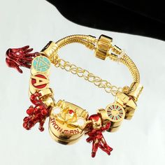 Marvel Universe brings you this exquisite 18k Gold, Silver And Stainless Steel Official Iron Man Unisex Charm Bracelet. Excellent Unisex gift for any age, gender or style type. The gold stainless steel Charms are crafted with extreme attention to every detail, the details Is what makes this charm bracelet One-Of-A-Kind and unique as you will NOT find such beautiful craftsmanship in every inch of ANY CHARM Bracelet In the industry. The Facts: This beautiful Charm Bracelet Won’t Change colors, tur Marvel Charm Bracelet, Universe Vintage, Marvel Jewelry, Jewelry Wishlist, Pandora Bracelet Charms, Unisex Gift, Vintage Iron, Premium Gift, Unisex Gifts