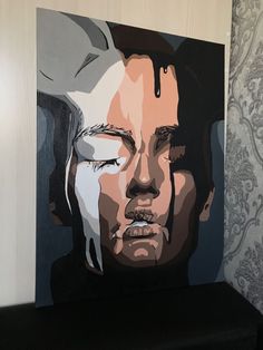 a painting of a man's face on a wall