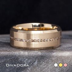 a gold wedding band with white diamonds on the inside and outside, sitting on top of a rock