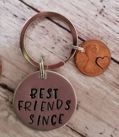 two pennys and a keychain with the words best friends since on them