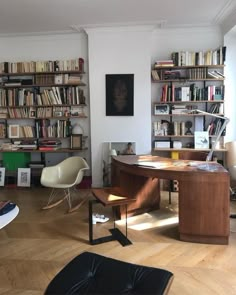 a living room filled with furniture and lots of books