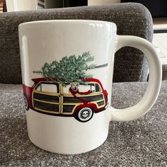 a coffee mug with a dog in the back and a christmas tree on the top