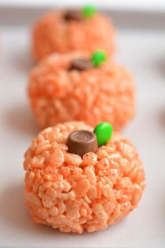 some kind of food that looks like pumpkins on top of rice krispy treats