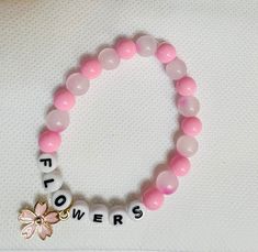 BlackPink's Jisoo Flowers bracelet Pink Name Bracelet For Friendship, Adjustable Pink Name Bracelet, Adjustable Round Pink Name Bracelet, Trendy Pink Flower Jewelry, Trendy Handmade Pink Crystal Bracelet, Pink Beaded Flower Charm Bracelet, Casual Pink Jewelry For Gifts, Casual Pink Bracelet As Gift, Casual Pink Bracelet As A Gift