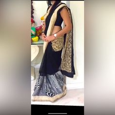 A Beautiful Black And Modern Print Saree With Some Embroidery, Worn For Two Hours. Formal Black Pre-draped Saree With Resham Embroidery, Elegant Black Silk Pre-draped Saree, Black Silk Pre-draped Saree With Sheer Dupatta, Black Silk Fitted Saree, Fitted Black Silk Saree, Bollywood Style Black Silk Blouse Piece, Black Georgette Pre-draped Saree With Resham Embroidery, Black Organza Sets With Zari Work, Traditional Black Organza Choli