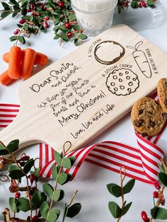 some cookies and carrots on a table next to a wooden sign that says dear santa