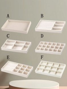 four white trays with compartments on each side and the letters abc, d, e, f