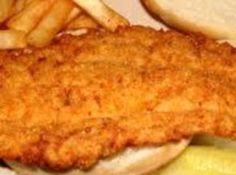 a fried fish sandwich with french fries and pickles