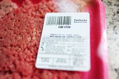 a close up of a piece of meat on a plate with a barcode label