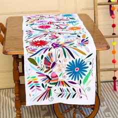 This Amazing  Otomi table runner handcrafted needlework by artisans from Tenango de Doria Hidalgo Mexico. Made with white cotton fabric and embroidered with the vibrant Mexican colors of Otomi textiles. Each piece is lovingly crafted and unique. One of-a-kind!  There is no other like it! - 100% cotton - Measurements: 75"H x 18.5 " W  - All items ship from US All Mi Mundo Mexicano items are 100% handmade by artisans in Mexico. Each stitch and item is completely unique and one-of-a-kind, so you'll never find two that are exactly the same! All items may vary slightly in size, color, and design - that's what makes handmade items so special and charming! *Your Purchase supports artisans craft and families ! Mexico Home Decor, Mexican Colors, Mexican Textiles, Leather Embroidery, Embroidered Table Runner, Home Decor Table, White Cotton Fabric, Traditional Table, Decor Table