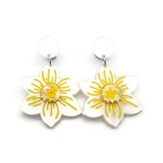 "These white and yellow daffodil earrings are the perfect statement piece for spring. These springy flower earrings are laser cut from acrylic and handpainted to create a vintage inspired design that is lightweight and comfortable to wear.  The best bits in a nutshell: - Nickel free earring posts - meaning no more irritated ears for those who are sensitive - Lightweight acrylic design - so you can wear them in comfort all day Other details: - Earrings measure 55 mm (2.17\") from top of stud to b Spring White Birth Flower Jewelry, Yellow Flower Charm Earrings For Spring, White Flower Earrings For Spring, Yellow Spring Earrings, Spring White Jewelry With Matching Earrings, White Jewelry With Matching Earrings For Spring, White Flower Earrings With 3d Flowers For Spring, White Flower Charm Jewelry For Spring, White Flower Decorated Earrings For Spring