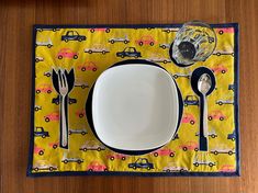 a place mat with utensils and plates on it