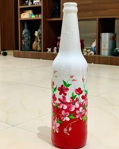 a painted glass bottle sitting on the floor